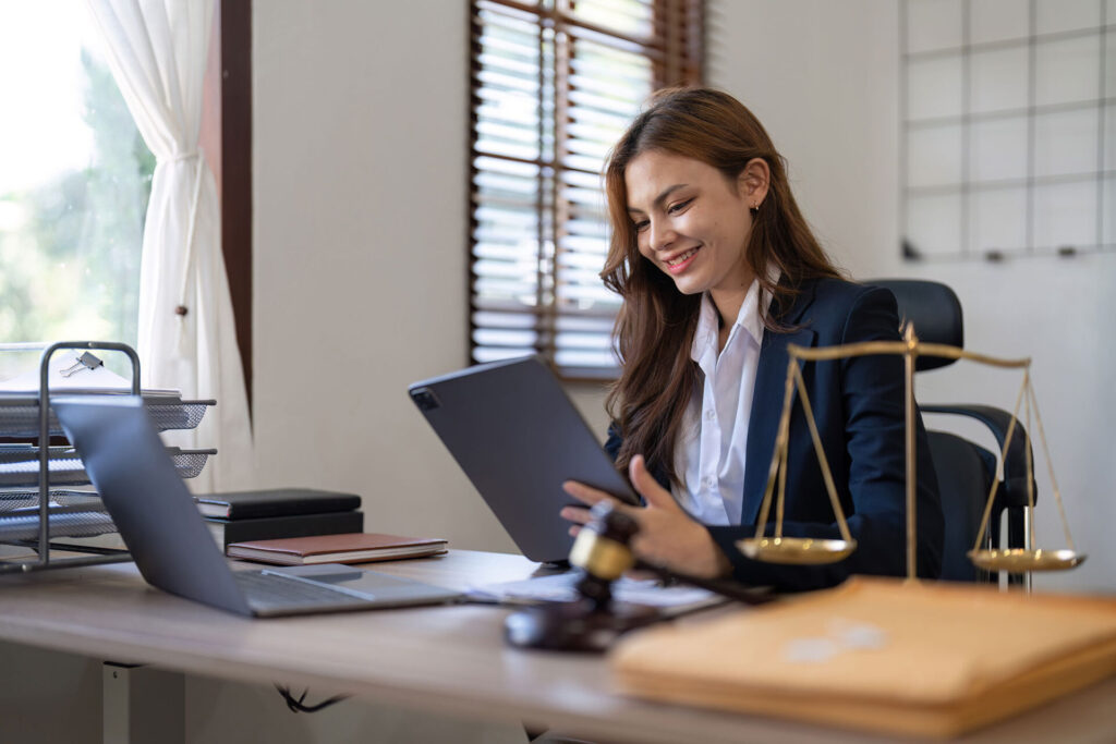 young lawyer in office Business woman and lawyers contract papers with scale on desk in office. Law legal services advice Justice | ANG